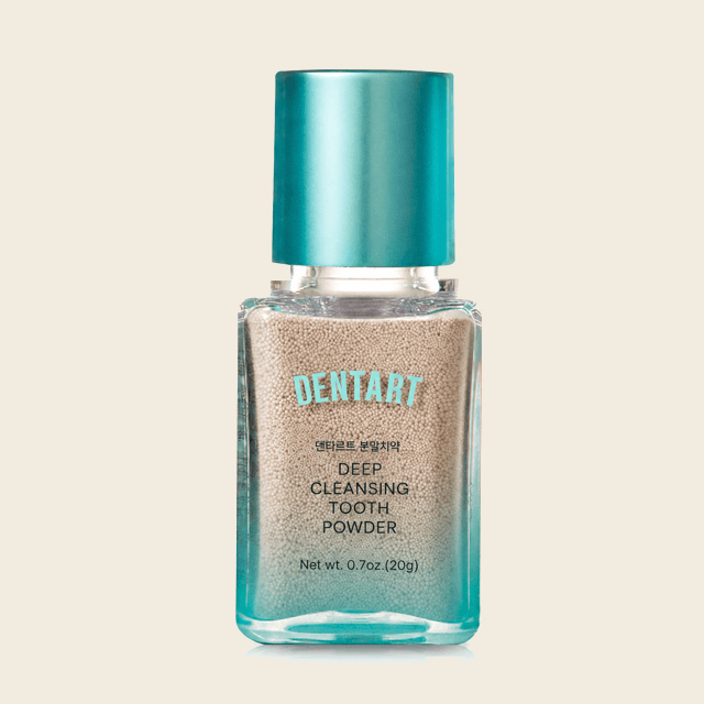 Dentart Deep Cleansing Tooth Powder in a clear bottle with a metallic teal cap
